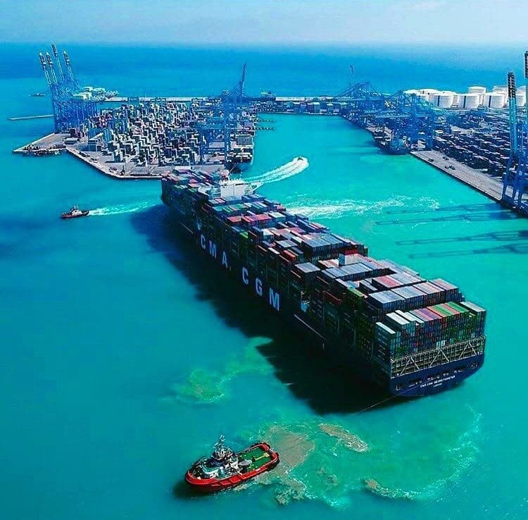 Aerial view of a container yard with stacked boxes and handling equipment